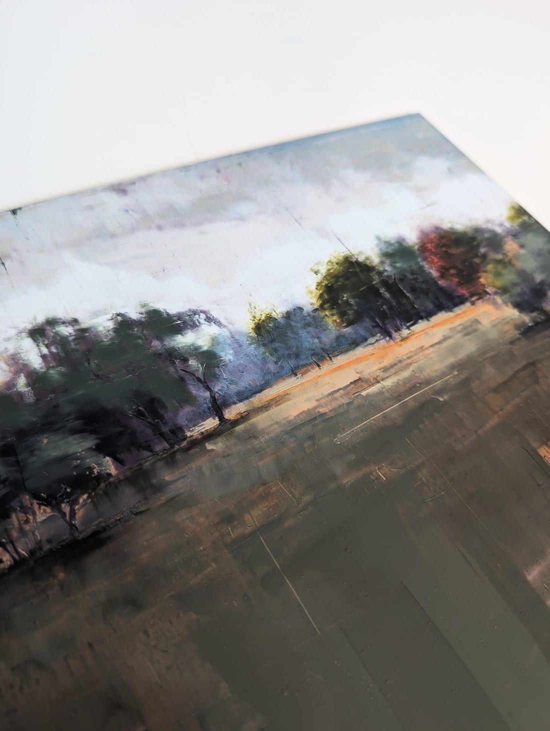 Close view of the paint surface: glazed layers and scraped marks below the treeline